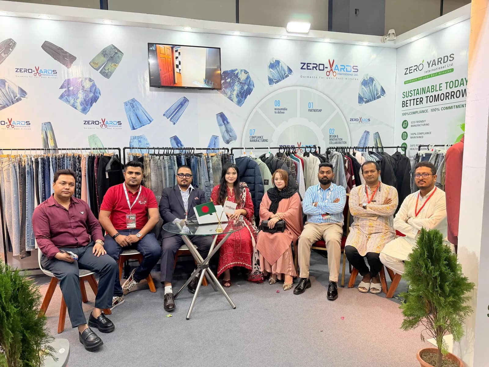 Zero Yards International team seated at the booth table