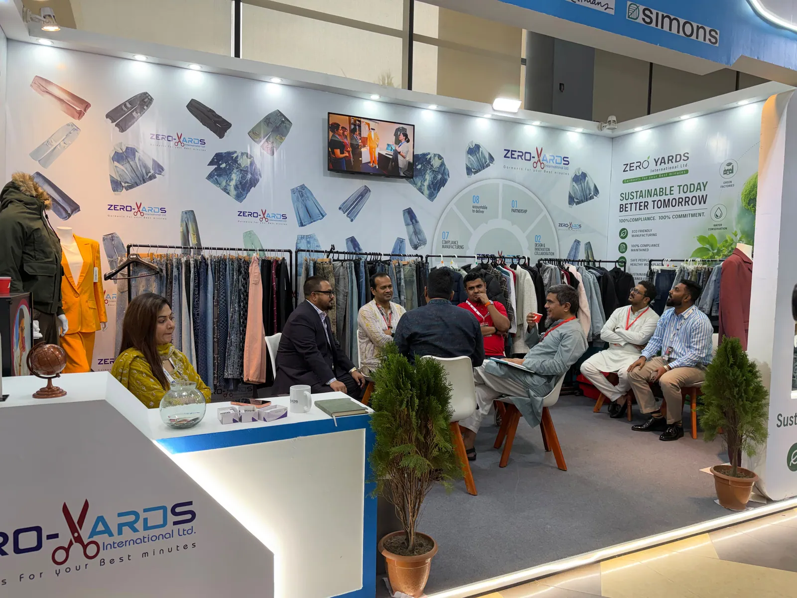 Zero Yards International team in conversation at the booth