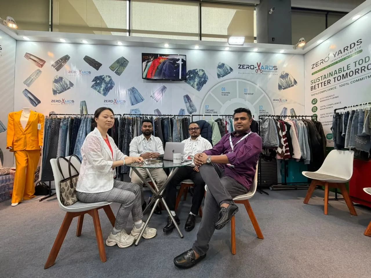 Zero Yards International team meeting at the booth table